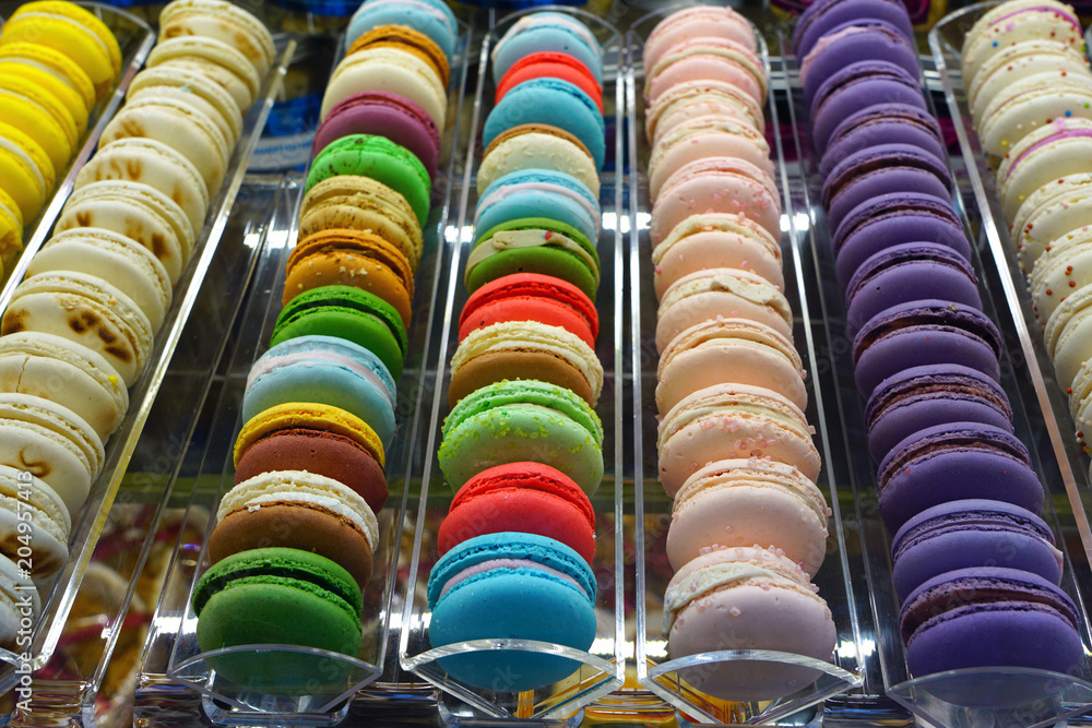 Fototapeta premium Rows of colorful macaron cookies in a pastry shop