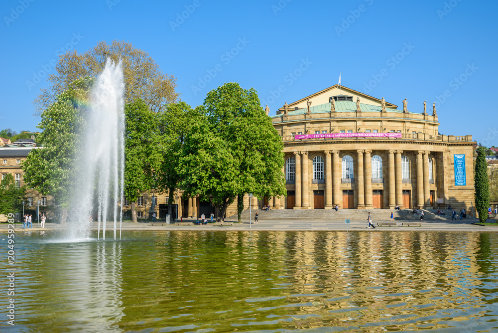 Stuttgart State Theatre Opera building and fountain in Eckensee lake, Germany
