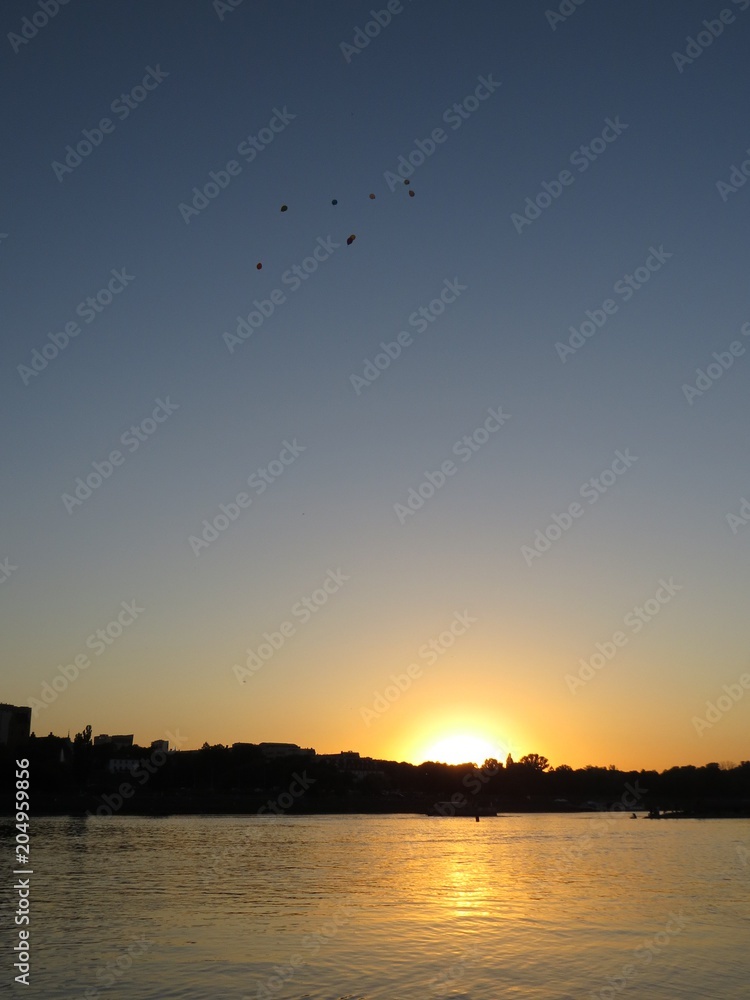 Beautiful City Skyline with Flying Balloons on Sky Seen During Sunset over Vistula River, Warsaw, Poland Beautiful City Skyline with Flying Balloons on Sky Seen During Sunset over Vistula River, Warsaw, Poland