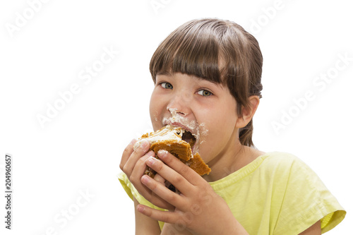 Girl eating cake. Isolated on white background.