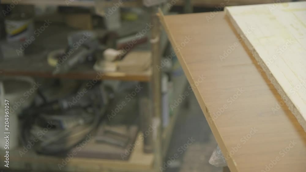 Close up, worker uses mallet on wood plank Close up, worker uses mallet on wood plank