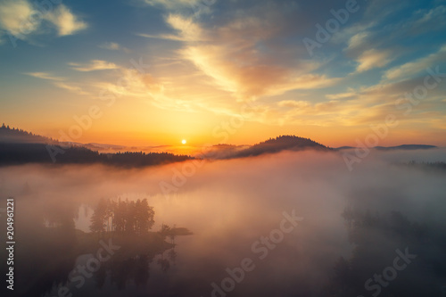 Aerial view of morning fog on the lake, sunrise shot