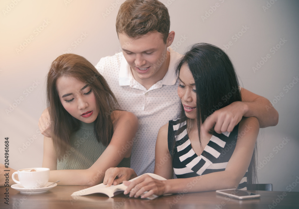 Group of friend reading book and talking in coffee shop Group of friend reading book and talking in coffee shop