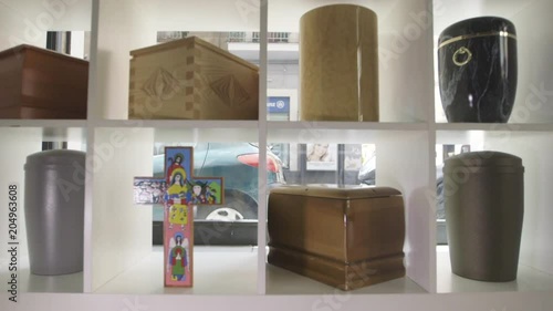 Tacking shot, cremations urns on shelves