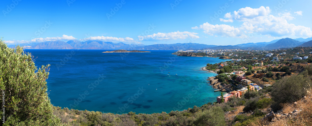 Panoramic high point view at sunset of the picturesque gulf of Mirambello, with the island of Agioi Pantes and the town of Agios Nikolaos, Crete, Greece