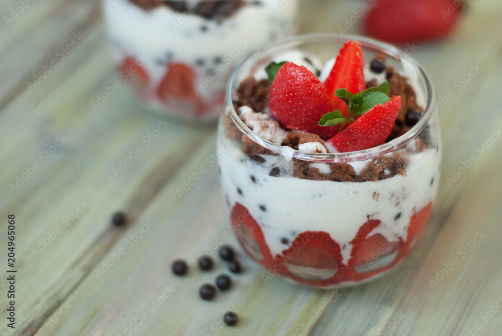Strawberry Cake in Glass with White Crea mans Strawberry. Homemade summer dessert on white rustic table. Strawberry Cake in Glass with White Crea mans Strawberry. Homemade summer dessert on white rustic table.