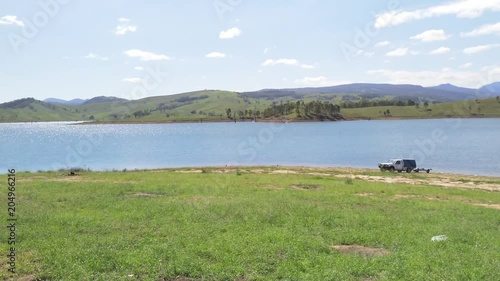 Australian lakes, UHD pan view of Lake St Clair and surrounding mountain, nature landscapes, on a sunny summer day, in Sydney, Australia
