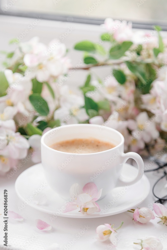 Fototapeta premium cup of morning coffee with flowers
