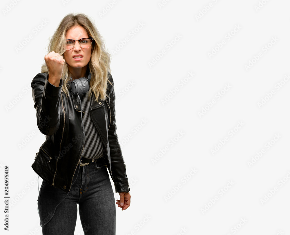 Young student woman with headphones irritated and angry expressing negative emotion, annoyed with someone Young student woman with headphones irritated and angry expressing negative emotion, annoyed with someone