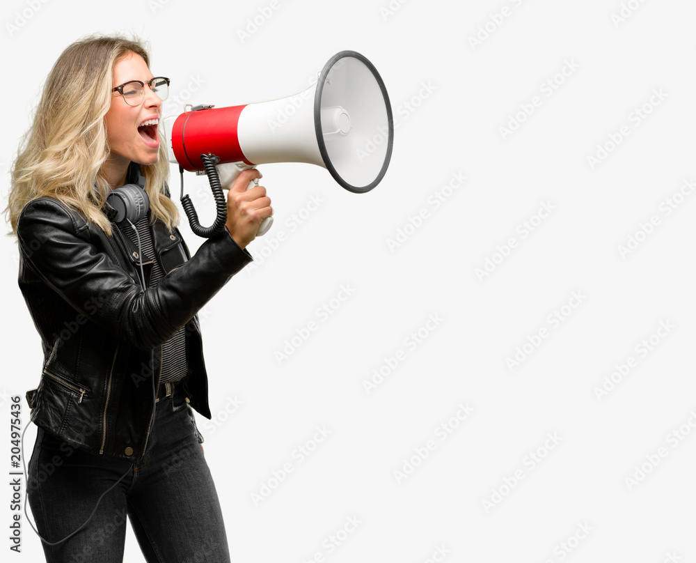 Young student woman with headphones communicates shouting loud holding a megaphone, expressing success and positive concept, idea for marketing or sales Young student woman with headphones communicates shouting loud holding a megaphone, expressing success and positive concept, idea for marketing or sales