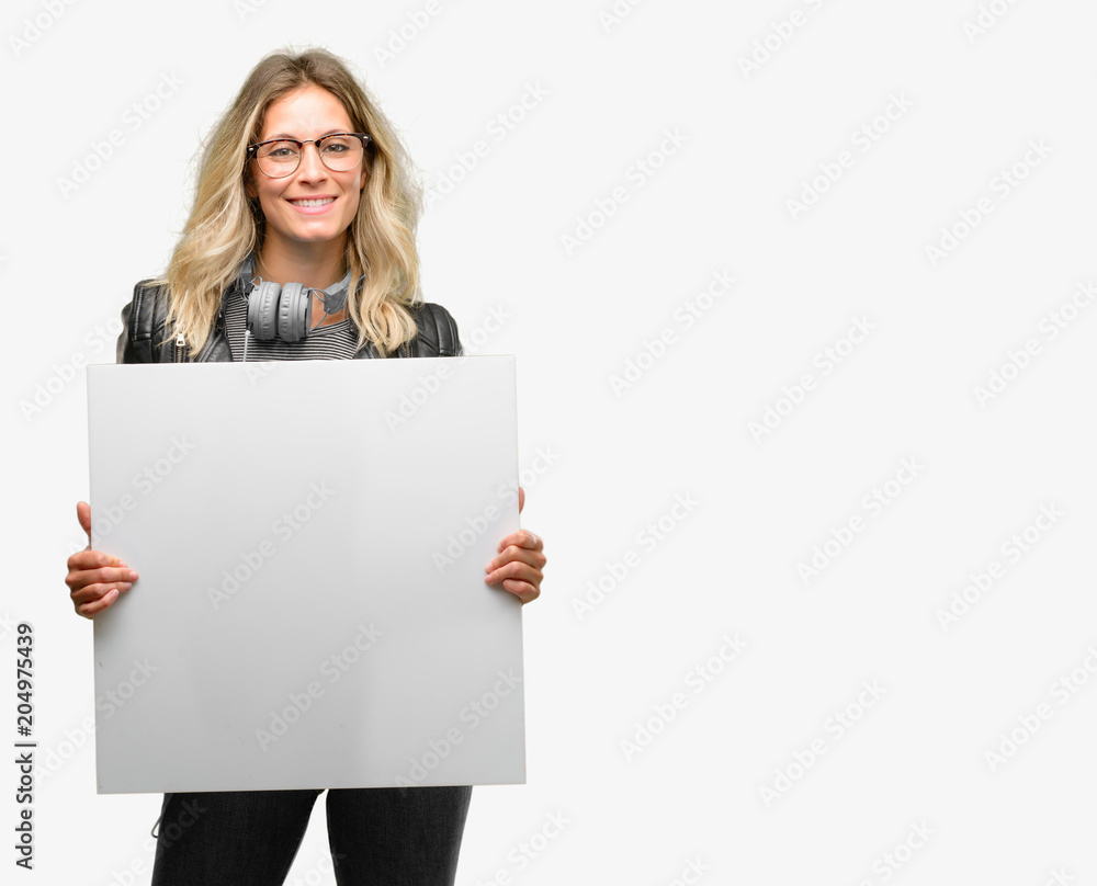 Young student woman with headphones holding blank advertising banner, good poster for ad, offer or announcement, big paper billboard Young student woman with headphones holding blank advertising banner, good poster for ad, offer or announcement, big paper billboard