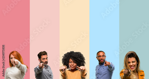Cool group of people, woman and man pointing to the front with finger