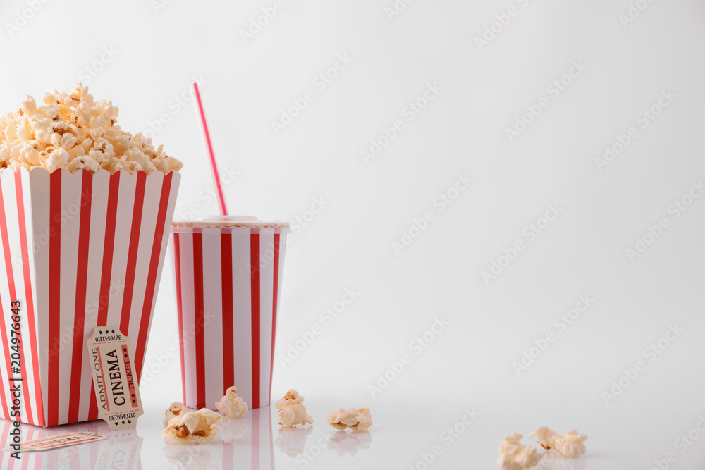 Drink popcorn and movie tickets on white background