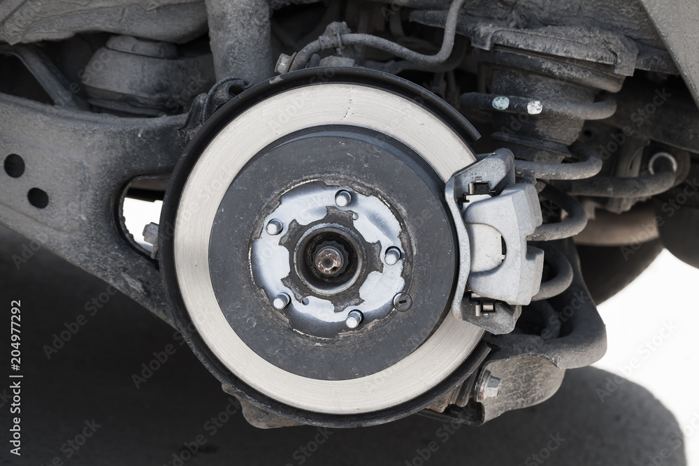 Close-up photo of brake disk and suspension Close-up photo of brake disk and suspension