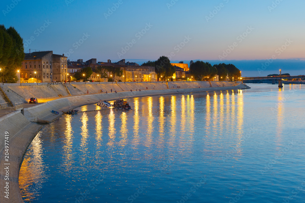 Obraz premium People walking embankment Arles, France