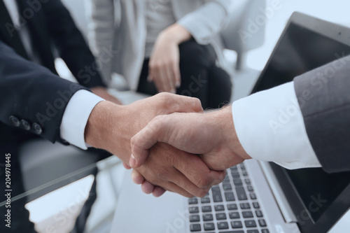 Two confidence businessman shaking hands close-up