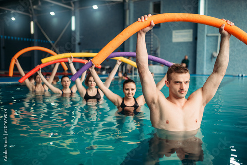 Fototapeta Naklejka Na Ścianę i Meble -  Instructor and class on workout in swimming pool