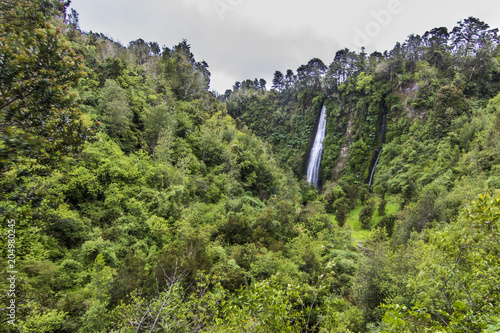 Tocoihue waterfalls at Chiloe island an amazing and wild landscape like in an adventure film, a green full of life scenery with the river going down finding the exit to the Pacific Ocean. Chile.