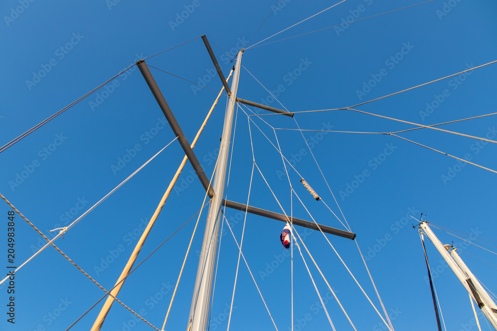 rigging mast and halyards of a sailing boat under a beautiful blue sky rigging mast and halyards of a sailing boat under a beautiful blue sky