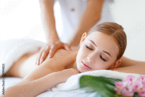 beautiful girl enjoys massage and spa treatments