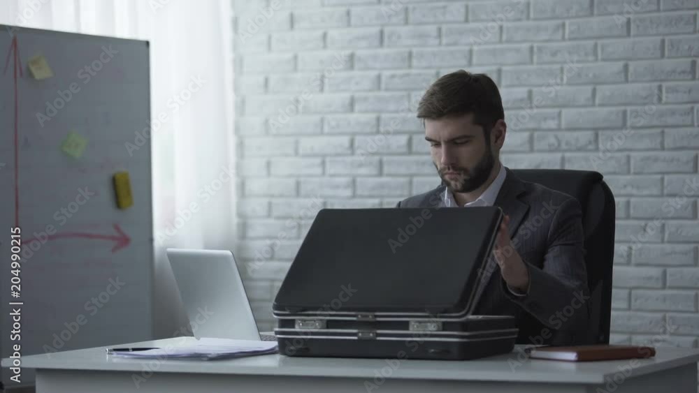 Man stealing some dollars from briefcase, corporate fraud, financial speculation Man stealing some dollars from briefcase, corporate fraud, financial speculation