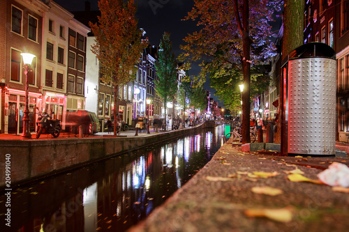 Canvas Print Red-light district in Amsterdam with narrow canals through the city with Night view