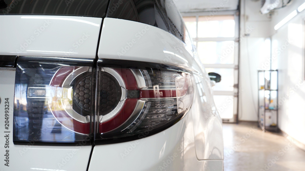 Fototapeta premium Car on a car wash, close-up headlight
