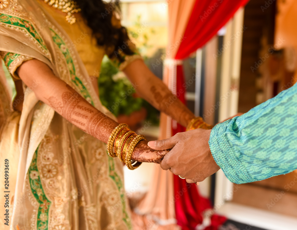 close up of bride and groom holding hands - Hindu bride with henna tattoo 