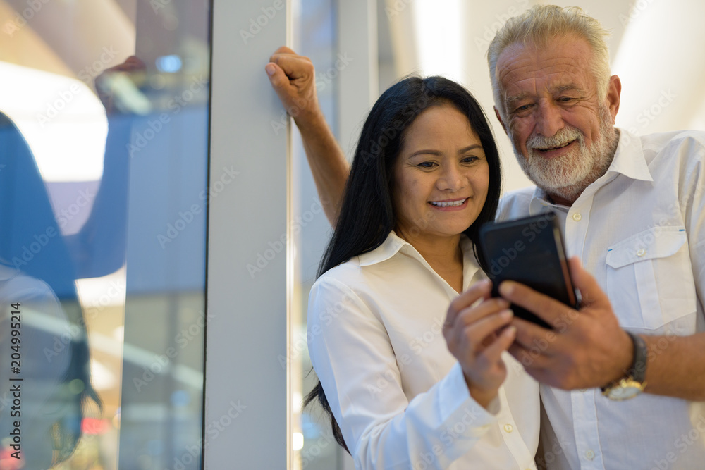 Mature multi-ethnic couple happy and in love while exploring the Mature multi-ethnic couple happy and in love while exploring the