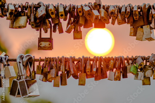 Sunrise Under the decorative wire fence (key hanging for decoration) for tourists to take a picture at the scenic spot (Hill Nangyaphaya) Chanthaburi Province, Thailand.