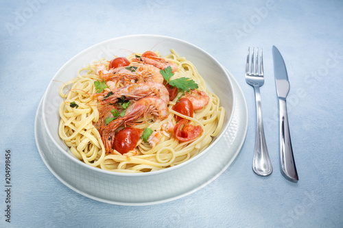Linguine with shrimps and cherry tomatoes. The shrimps of the Mediterranean are precious crustaceans, the sauce is also accompanied by pepper and fresh parsley