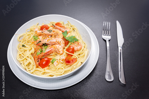 Linguine with shrimps and cherry tomatoes. The shrimps of the Mediterranean are precious crustaceans, the sauce is also accompanied by pepper and fresh parsley