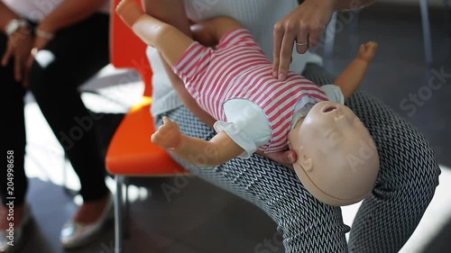 Wallpaper Mural Close up, instructor performs CPR on infant mannequin Torontodigital.ca