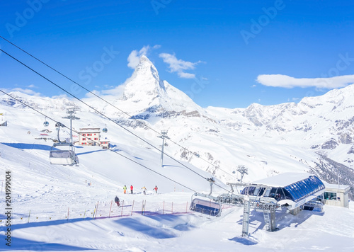 ZERMATT, SWITZERLAND - APRIL 14, 2018: Skier in Cable car to Matterhorn Glacier Paradise with cloudy blue sky in cold summer day at Zermatt, Switzerland