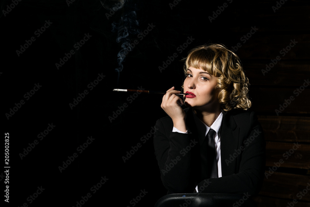 Fototapeta premium businesswoman with cigarette on a dark background, stylized retro portrait