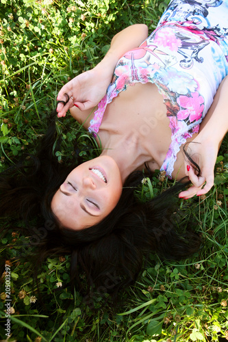 The girl lays on a grass a meadow 
