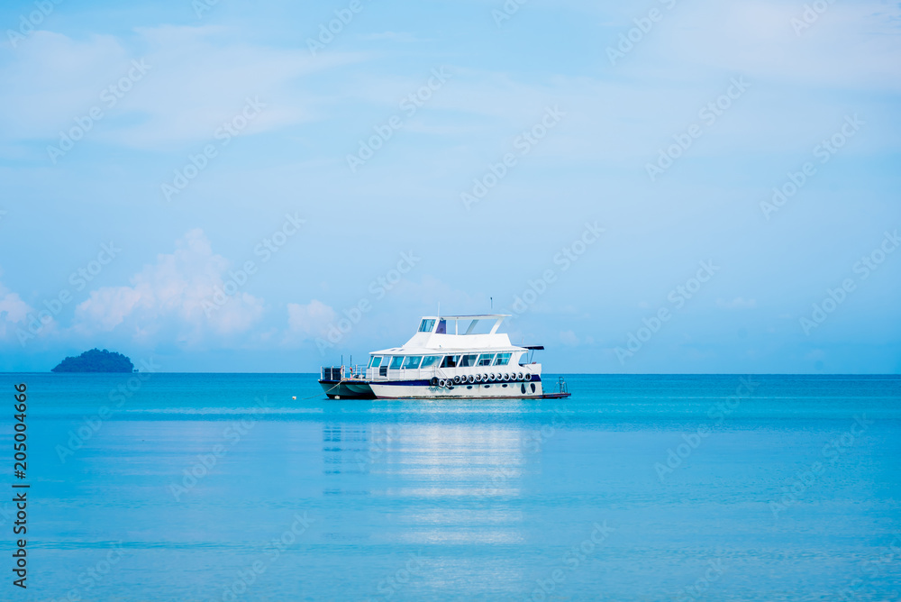 Boat sailing in sea go to island with blue cloud sky background.