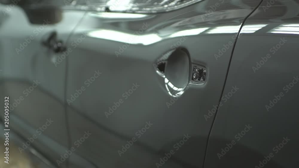 Reflection off black car in factory, close up Reflection off black car in factory, close up