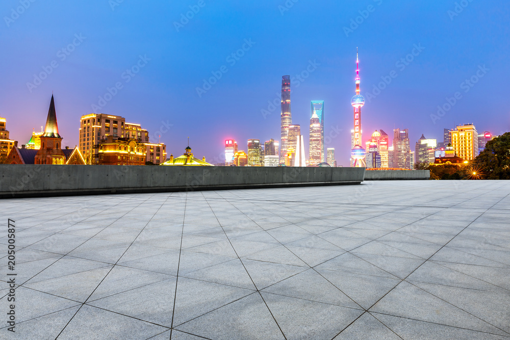 empty square floor and beautiful city skyline at night in shanghai