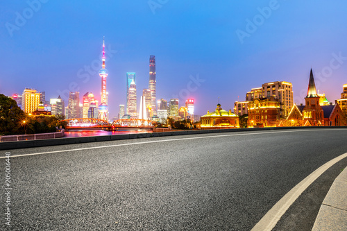clean asphalt road with city skyline background,shanghai,china