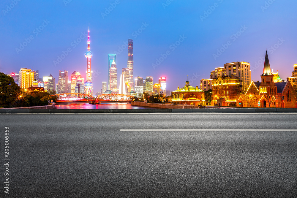 clean asphalt road with city skyline background,shanghai,china