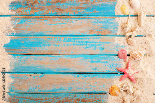 Photography Beach background - top view of beach sand with shells, starfish on wood plank in blue sea paint color background