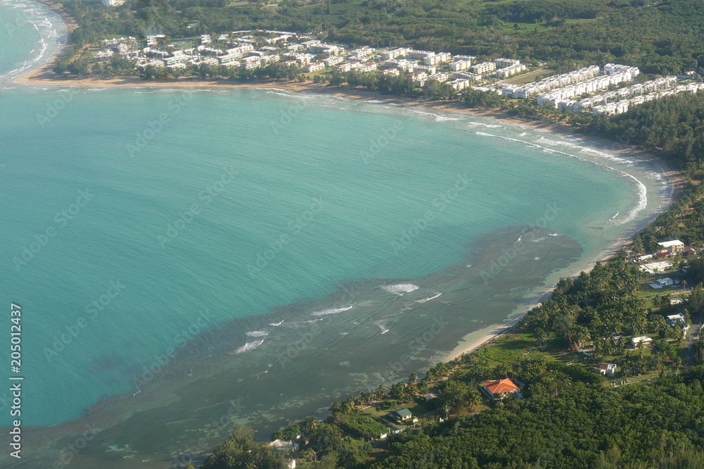 Aerial shot of Puerto Rico’s coastal areas with pristine waters and buildings near the shorelines