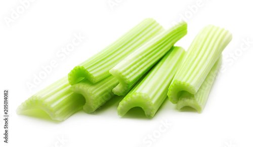 heap of green celery sticks isolated on white background