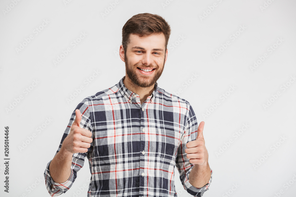 Portrait of a smiling young man showing thumbs up Portrait of a smiling young man showing thumbs up