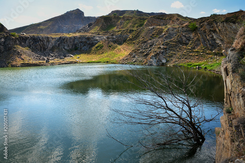 Iacobdeal lake ,formed in a collapsed mine gallery, near Macin mountains, Tulcea county, Romania photo