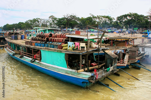 Barges anchored at Ayeyarwady river port in Mandalay, Myanmar © donyanedomam