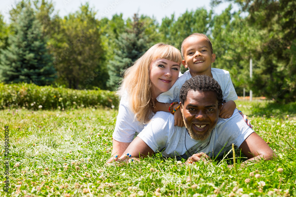 African American happy family: black father, mom and baby boy on nature. Use it for a child, parenting or love concept African American happy family: black father, mom and baby boy on nature. Use it for a child, parenting or love concept