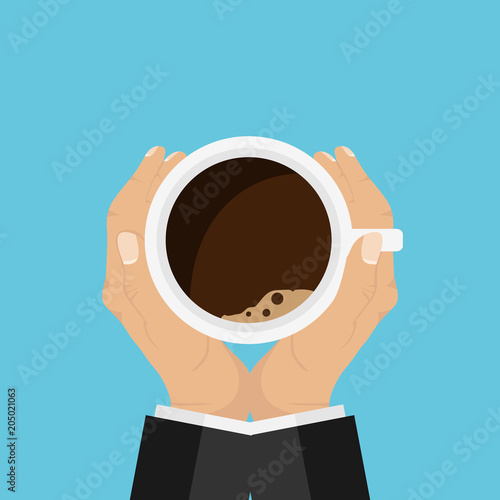 Hands holding a cup on both sides. A cup of coffee in the hands of a man.