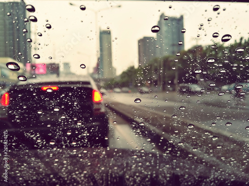 Rain drops in front of the car mirror.